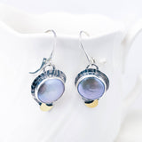 Silver earrings with freshwater pearls on a white background