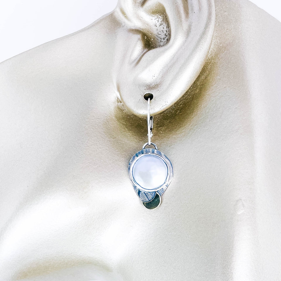 Silver earrings with freshwater pearls on manequin