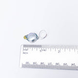Small earring with a freshwater pearl on a white background with a ruler for scale