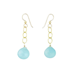 A pair of gold dangle earrings with a light blue teardrop-shaped stone pendant, shown on a white background.