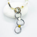 Necklace with circular pendant and beads on a white background