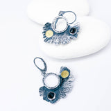 Pair of silver earrings with black spinel and gold accents