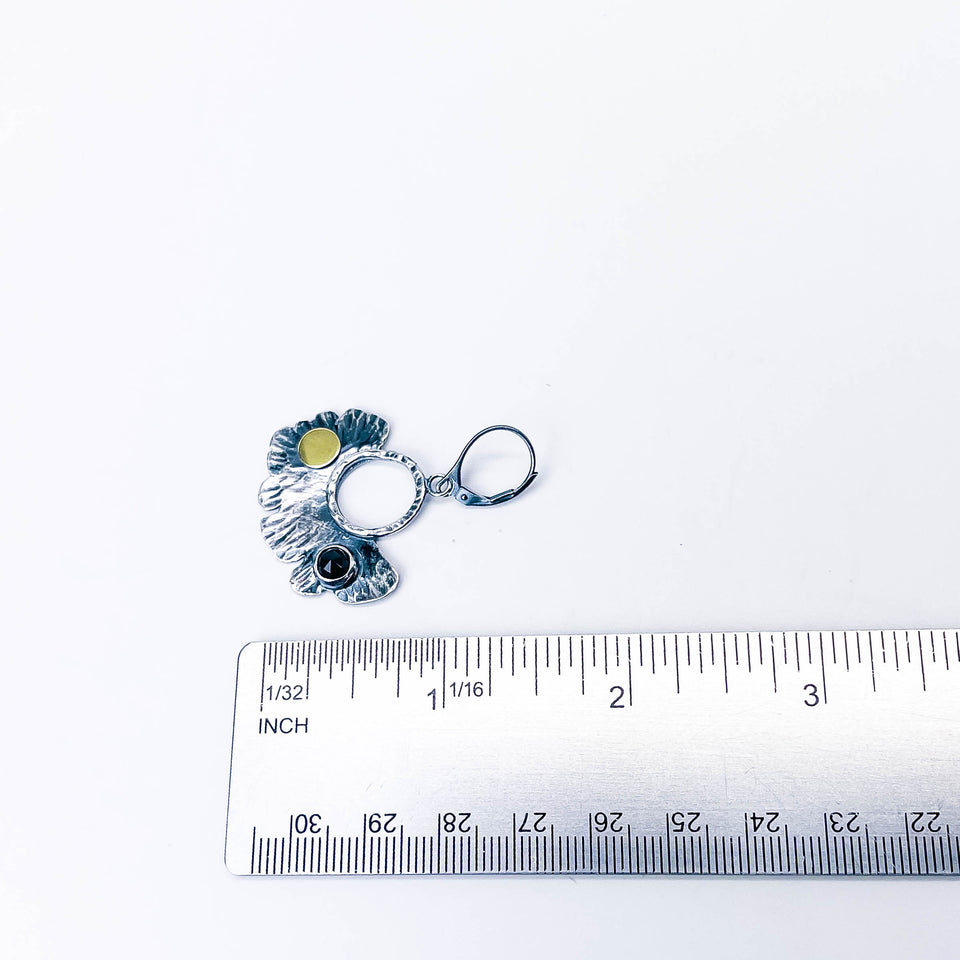 oxidized silver earrings with a black spinel gemstone and leaf design.