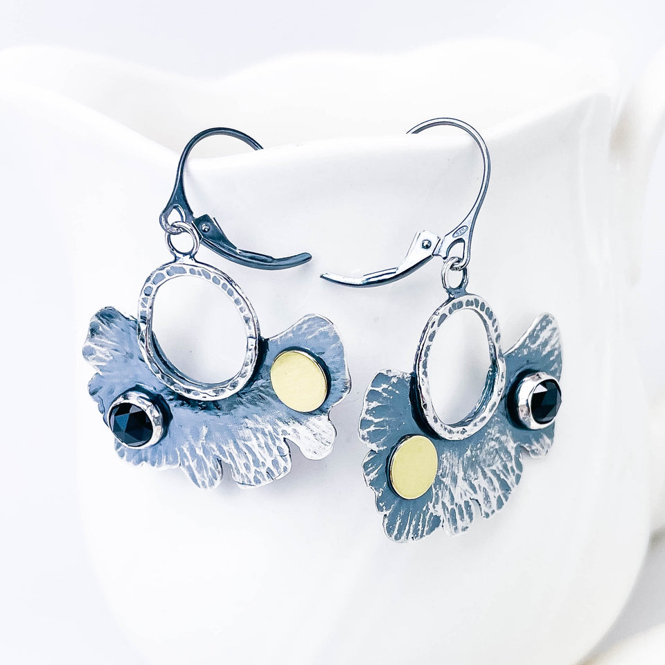 Pair of silver earrings with floral designs