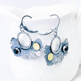 Pair of silver earrings with floral designs