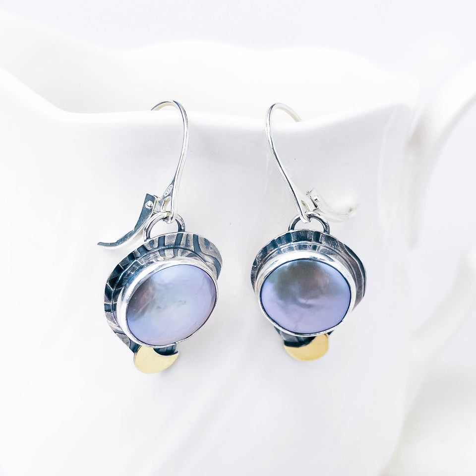 Silver earrings with freshwater pearls on a white background