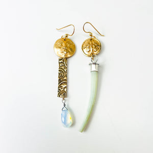 Bronze and green earrings on a white background
