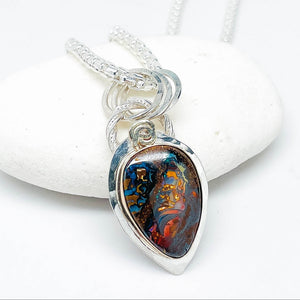 Teardrop-shaped pendant with colorful design on a white background