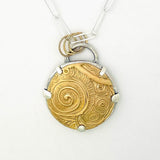 Necklace with a gold and silver pendant on a white background
