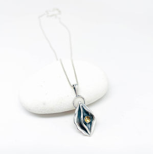 Silver necklace with a pendant on a white background