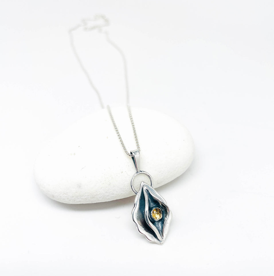 Silver necklace with a pendant on a white background