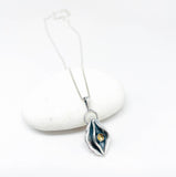 Silver necklace with a pendant on a white background