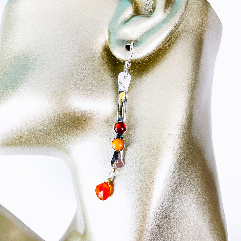 Earring with colorful beads on a mannequin ear