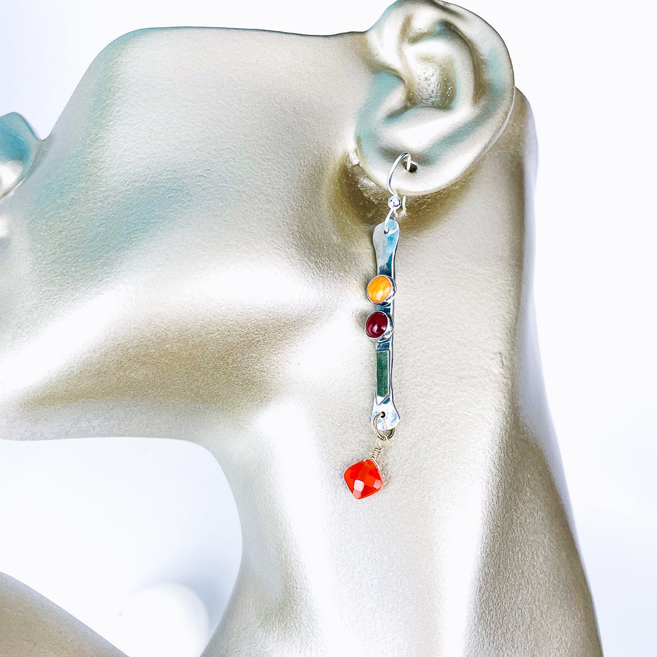 Earring with colorful beads on a mannequin ear